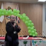 Woman talking with a balloon arch behind