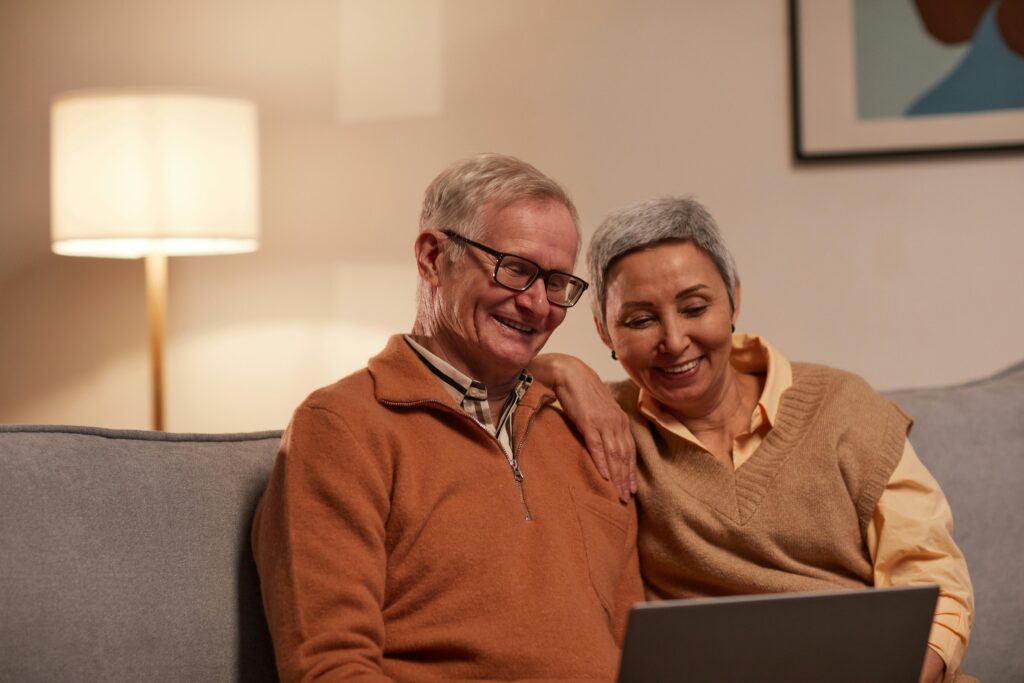 A man and woman looking at a laptop
