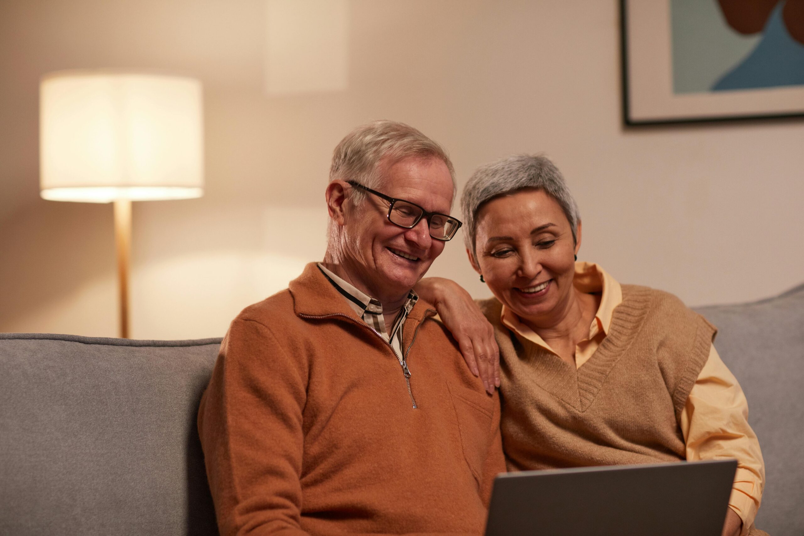 A man and woman looking at a laptop