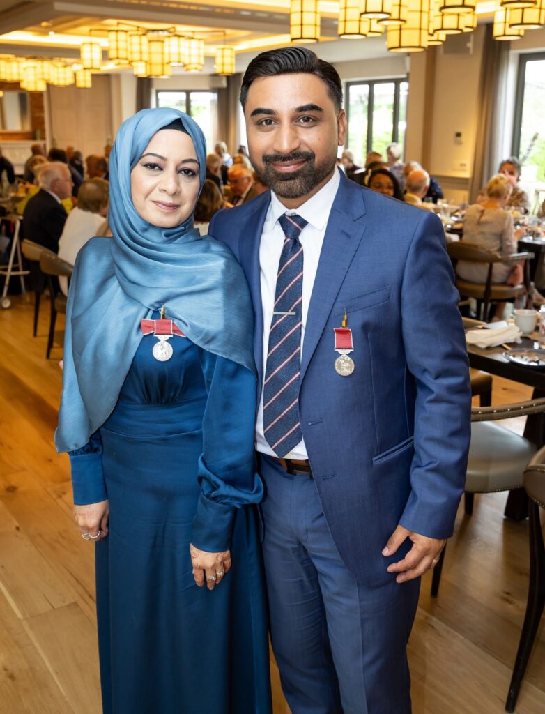 A woman and man at Buckingham Palace