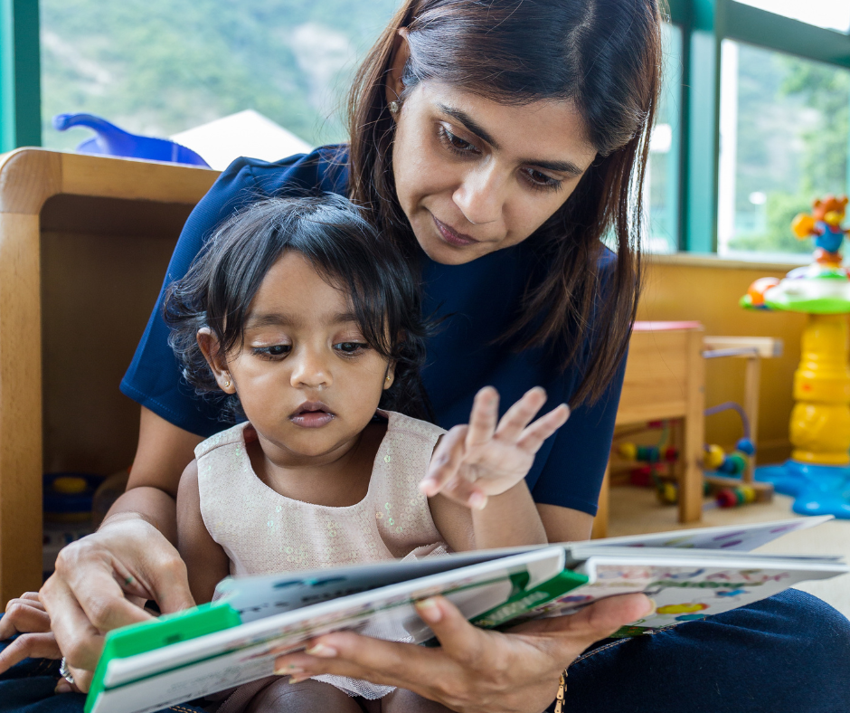 A woman reading a child a book
