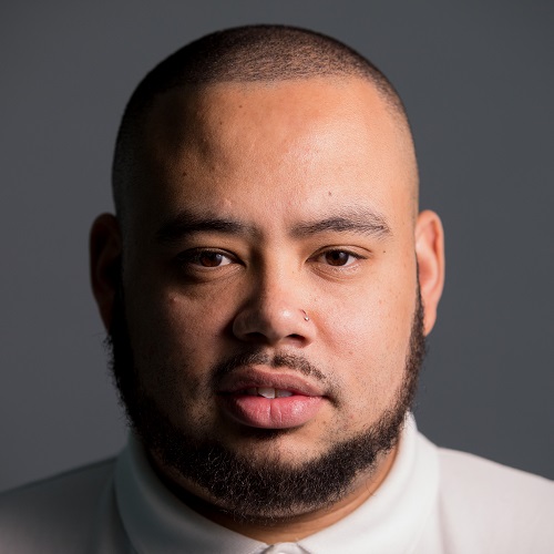 Head shot of man with cropped hair and trim beard