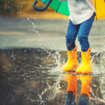 Child jumping in puddle