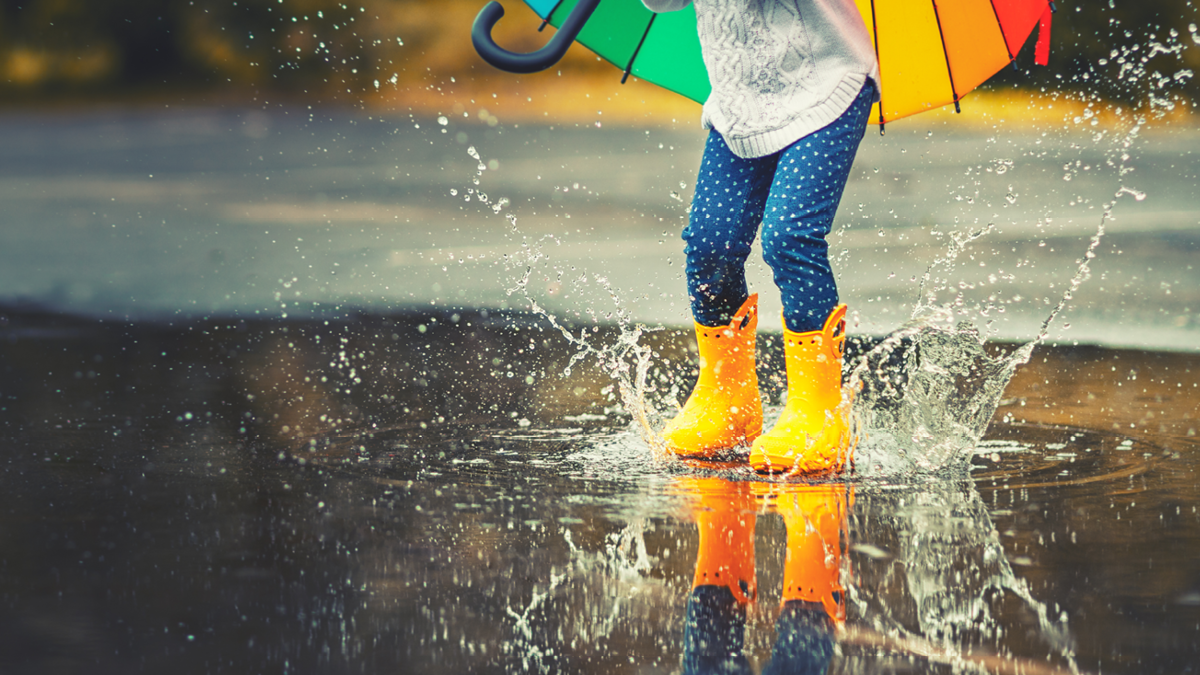 Child jumping in puddle