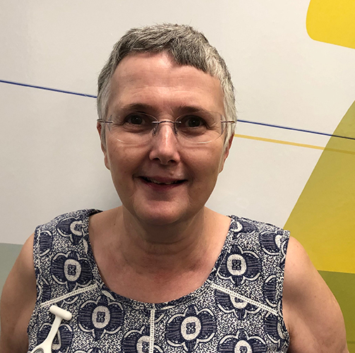 Head shot of woman with short grey hair and wearing glasses